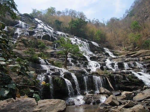 Water cascades down the broad, tiered rock face of Mae Ya Waterfall in Doi Inthanon National Park.
